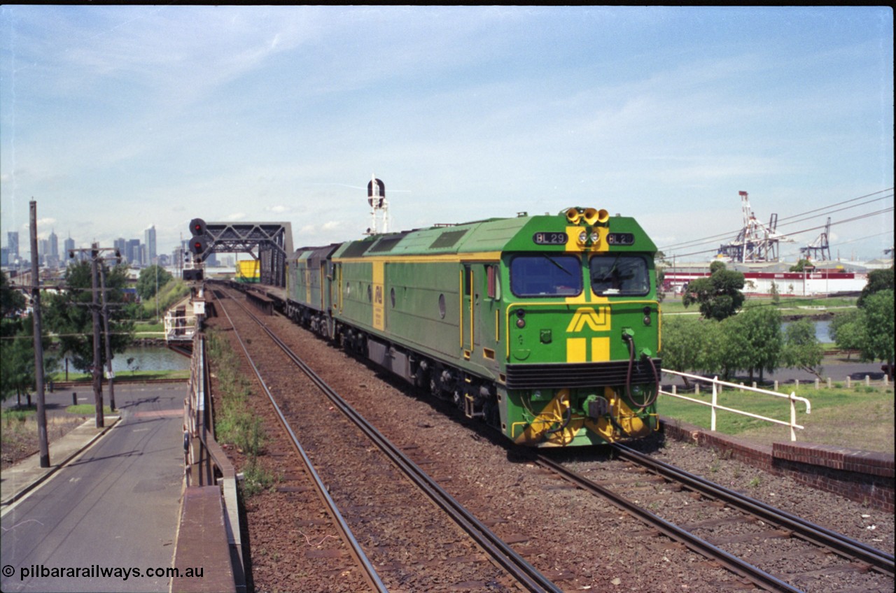 119-23
Maribyrnong River bridge, signal post 162, Australian National broad gauge locos BL class BL 29 Clyde Engineering EMD model JT26C-2SS serial 83-1013 and 700 class 703 AE Goodwin ALCo model DL500G serial G6059-1 working down Adelaide bound goods train 9145 across the river.
Keywords: BL-class;BL29;Clyde-Engineering-Rosewater-SA;EMD;JT26C-2SS;83-1013;