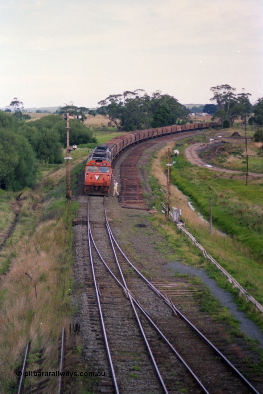 119-34
Warrenheip, V/Line broad gauge G class locos G 513 Clyde Engineering EMD model JT26C-2SS serial 85-1241 with another G class working down empty grain train 9125, swaps the electric staff for a caution order with the signaller, remains of removed Siding C on the right, semaphore signal post 2 and disc signal post 3.
Keywords: G-class;G513;Clyde-Engineering-Rosewater-SA;EMD;JT26C-2SS;85-1241;