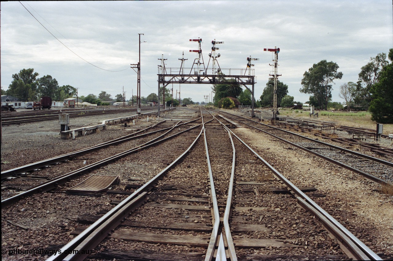 120-19
Benalla station yard, looking north, semaphore signal post 27 and gantry stripped dolls, tracks removed.
