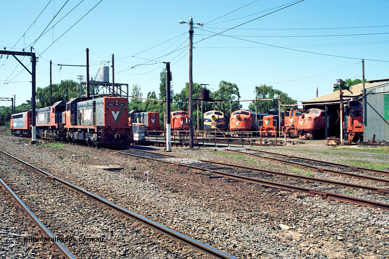 122-06
Traralgon loco depot overview, turntable and roundhouse, V/Line broad gauge loco classes present are all Clyde Engineering EMD models: T class G8B and G18B. X class G26C. A class AAT22C-2R rebuilt from ML2. B class ML2. Y class G6B. G class JT26C-2SS and S class A7. March 1992.
