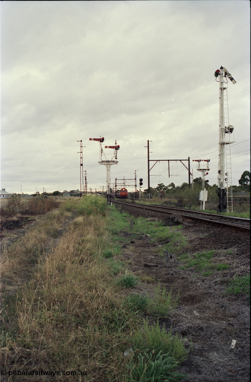 123-2-20
Sunshine track view, Newport - Sunshine Loop Line, looking towards Sunshine, double doll semaphore signal posts 36 and pulled off semaphore signal post 49, G class arriving with an up Brooklyn bound Apex quarry train.
