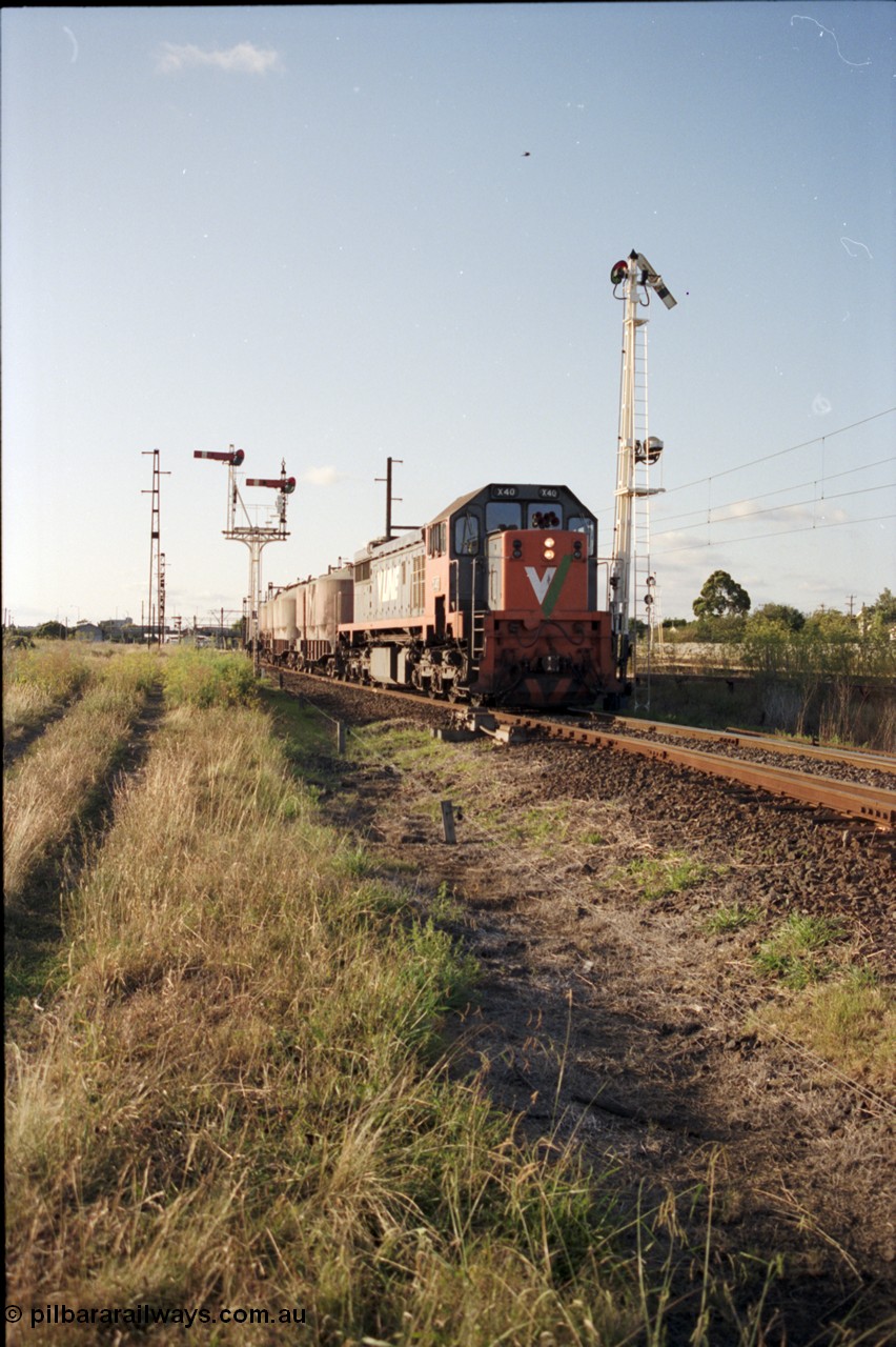 124-10
Sunshine V/Line broad gauge up goods train taking Newport Loop Line with X class X 40 Clyde Engineering EMD model G26C serial 70-703, semaphore signal posts 49 pulled off for movement, semaphore signal post 36 behind train
Keywords: X-class;X40;Clyde-Engineering-Granville-NSW;EMD;G26C;70-703;
