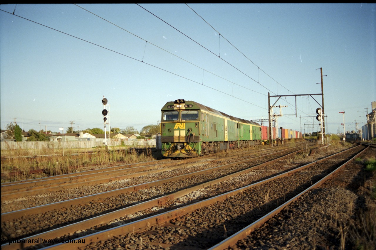 124-19
Sunshine broad gauge Australian National BL classes Clyde Engineering EMD model JT26C-2SS serial 83-1014 and BL 35 Clyde Engineering EMD model JT26C-2SS serial 83-1019 with a down Adelaide bound goods train head off the Independent Through Goods line and cross over the passenger lines heading for the main western line.
Keywords: BL-class;BL30;Clyde-Engineering-Rosewater-SA;EMD;JT26C-2SS;83-1014;