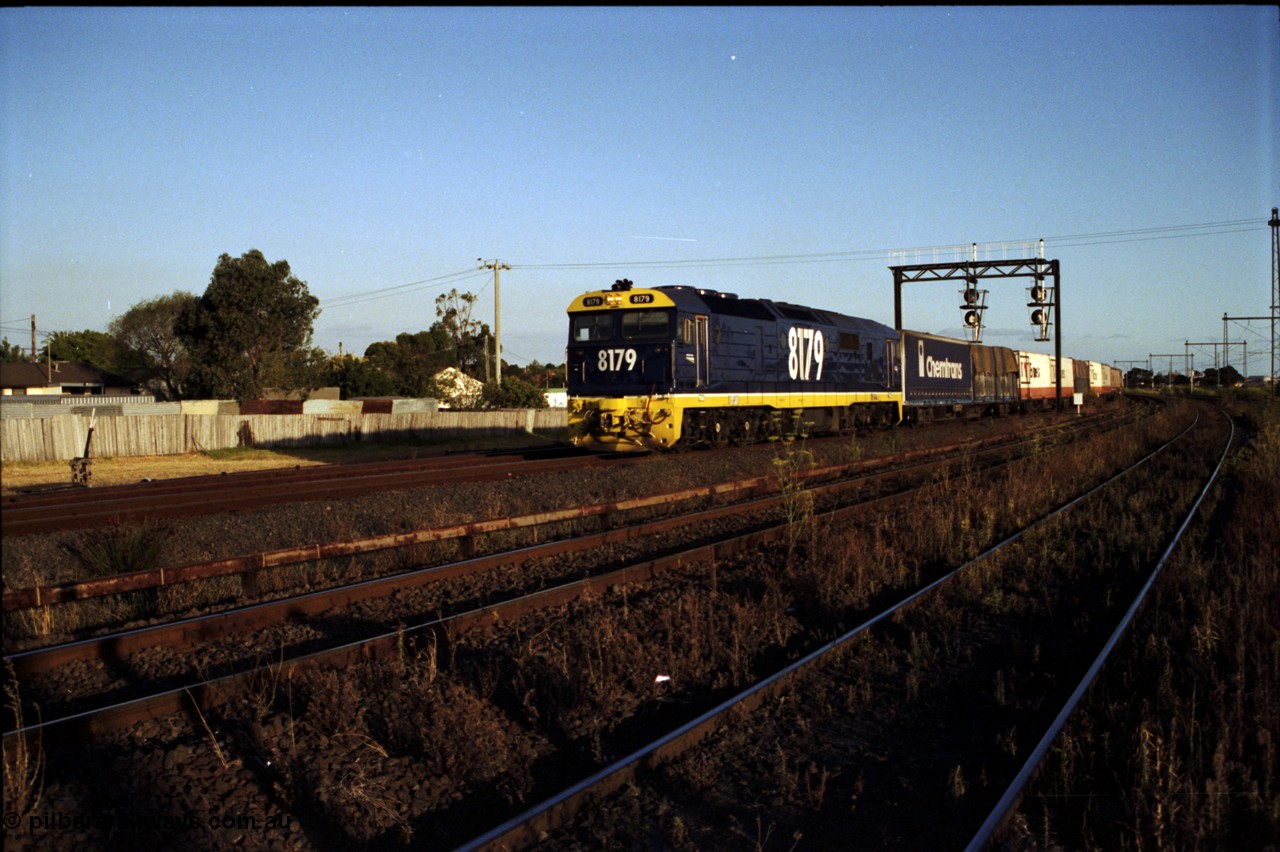 124-22
Sunshine Loop, standard gauge NSWSRA 81 class 8179 Clyde Engineering EMD model JT26C-2SS serial 85-1098 in new Freight Rail Stealth livery with a down goods train passing under the searchlight signal gantry, the two lines in the foreground are the broad gauge Independent Through Goods Lines
Keywords: 81-class;8179;Clyde-Engineering-Kelso-NSW;EMD;JT26C-2SS;85-1098;