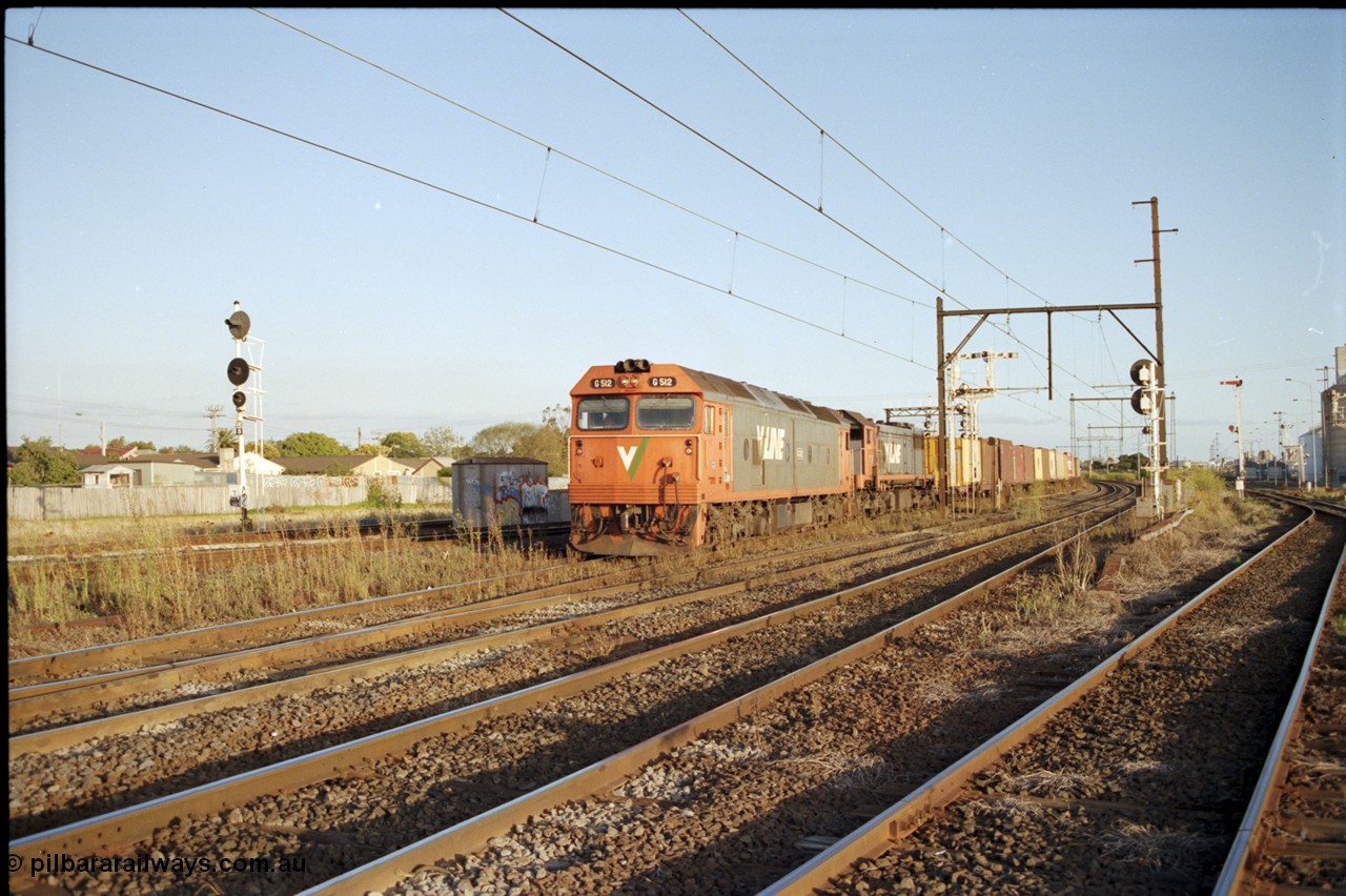 124-24
Sunshine V/Line down broad gauge Adelaide goods train with G class G 512 Clyde Engineering EMD model JT26C-2SS serial 84-1240 and X class X 51 Clyde Engineering EMD model G26C serial 75-798, train about to cross over passenger lines, signal post 31 back at stop on Independent Through Goods Line, up home searchlight signal post for the standard gauge Sunshine Loop on the left, Newport - Sunshine Loop Line at far right
Keywords: G-class;G512;Clyde-Engineering-Rosewater-SA;EMD;JT26C-2SS;84-1240;
