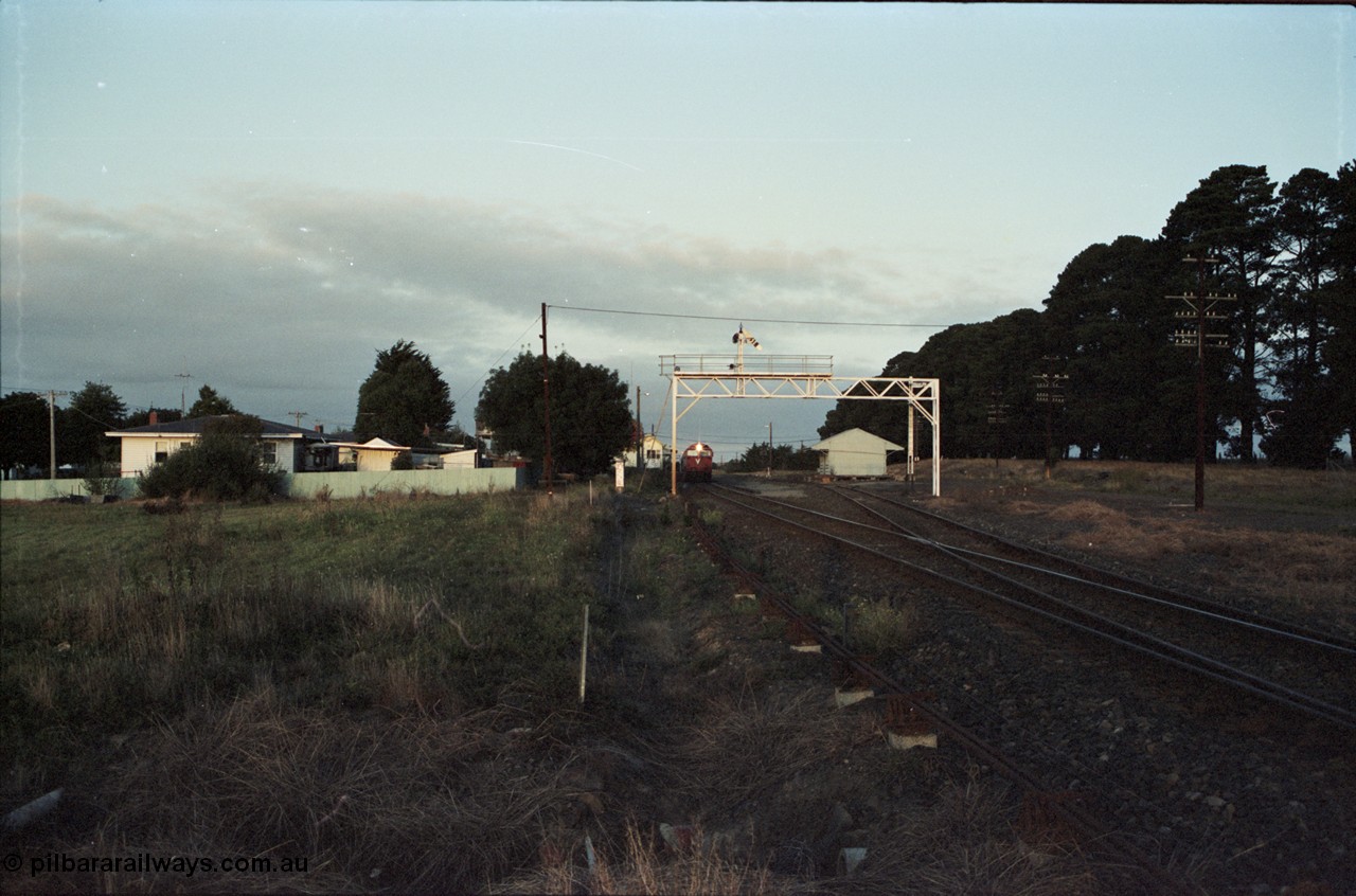 125-03
Ballan station overview, signal gantry, goods shed, broad gauge V/Line N class N 474 Clyde Engineering EMD model JT22HC-2 serial 87-1203 'City of Traralgon' with down pass, distant shot.
Keywords: N-class;N474;Clyde-Engineering-Somerton-Victoria;EMD;JT22HC-2;87-1203;
