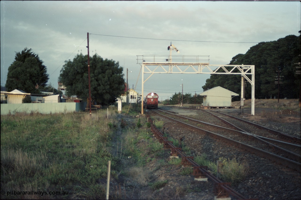 125-04
Ballan station overview, signal gantry, goods shed, V/Line broad gauge N class Clyde Engineering EMD model JT22HC-2 serial 87-1203 'City of Traralgon' with down pass.
Keywords: N-class;N474;Clyde-Engineering-Somerton-Victoria;EMD;JT22HC-2;87-1203;
