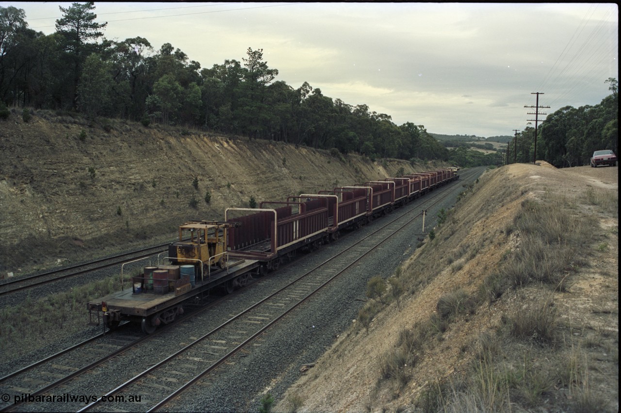 125-23
Heathcote Junction, V/Line broad gauge B class Clyde Engineering EMD model ML2 serial ML2-6 still in Victorian Railways livery leads a sleeper discharge train on the up broad gauge line, rolling down towards Wallan, trailing shot, V/Line VZSX class bogie sleeper waggons, train half empty, sleeper discharge machine.
