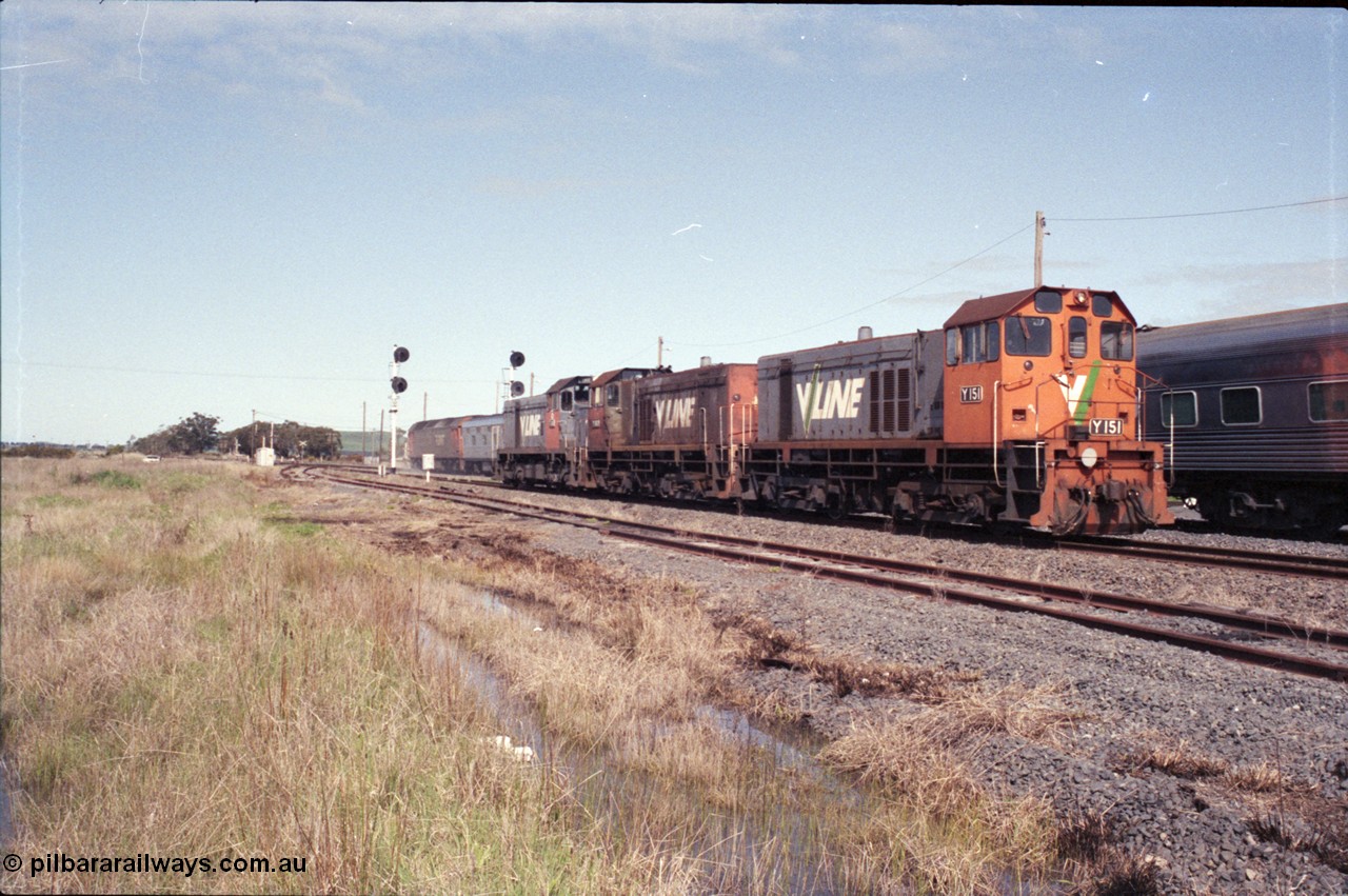 126-27
Wallan Loop, standard gauge V/Line G class G 518 Clyde Engineering EMD model JT26C-2SS serial 85-1231 runs the Up Melbourne Express passenger train, crossing relief light locos in loop at Wallan, V/Line Clyde Engineering EMD G8B model Y classes Y 151 serial 67-571 and Y 102 serial 63-292 and G18B T class T 411 serial 68-627.
Keywords: Y-class;Y151;Clyde-Engineering-Granville-NSW;EMD;G6B;67-571;