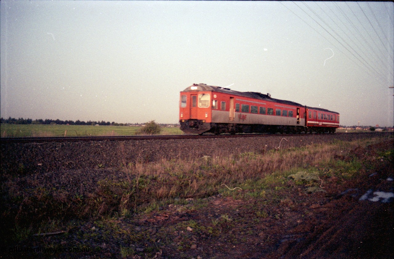 127-16
Deer Park West, V/Line broad gauge Tulloch Ltd DRC class diesel rail car and MTH class trailer hurry with a down passenger train.
Keywords: DRC-class;Tulloch-Ltd-NSW;