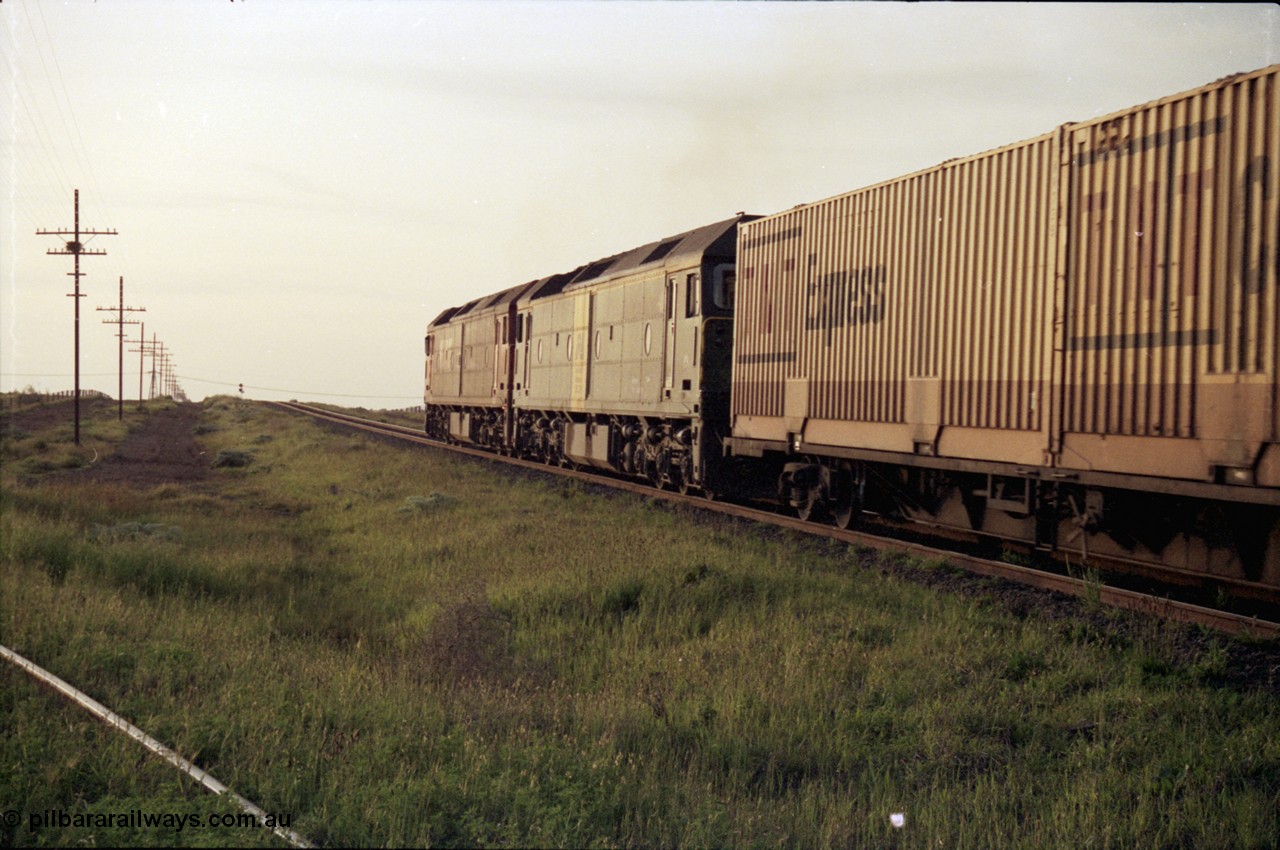 127-28
Deer Park West, V/Line G class G 512 Clyde Engineering EMD model JT26C-2SS serial 84-1240 leads Australian National BL class BL 27 Clyde Engineering EMD model JT26C-2SS serial 83-1011 with a down Adelaide bound goods, trailing shot as they power away.
Keywords: G-class;G512;Clyde-Engineering-Rosewater-SA;EMD;JT26C-2SS;84-1240;
