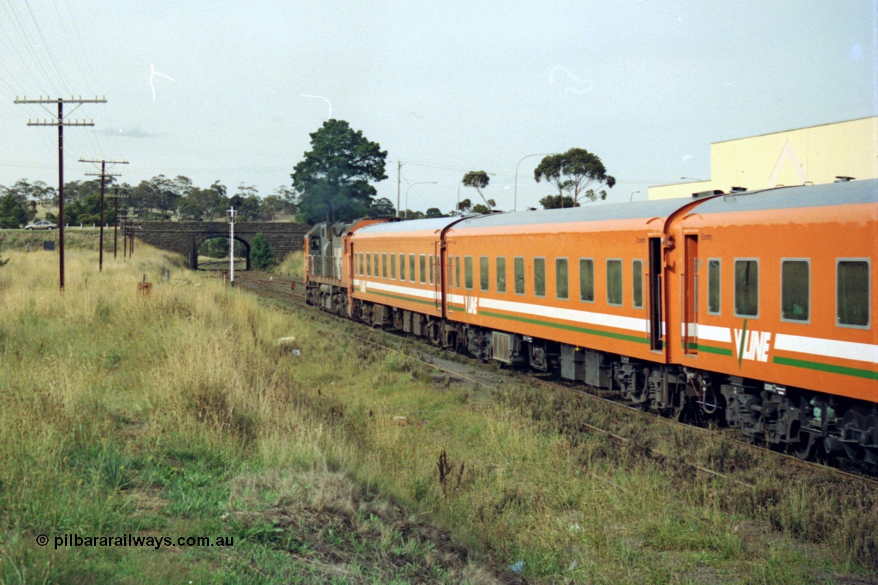 128-24
Sunbury, V/Line broad gauge N class N 461 'City of Ararat' Clyde Engineering EMD model JT22HC-2 serial 86-1190, N set, down passenger train departing, trailing view.
Keywords: N-class;N461;Clyde-Engineering-Somerton-Victoria;EMD;JT22HC-2;86-1190;