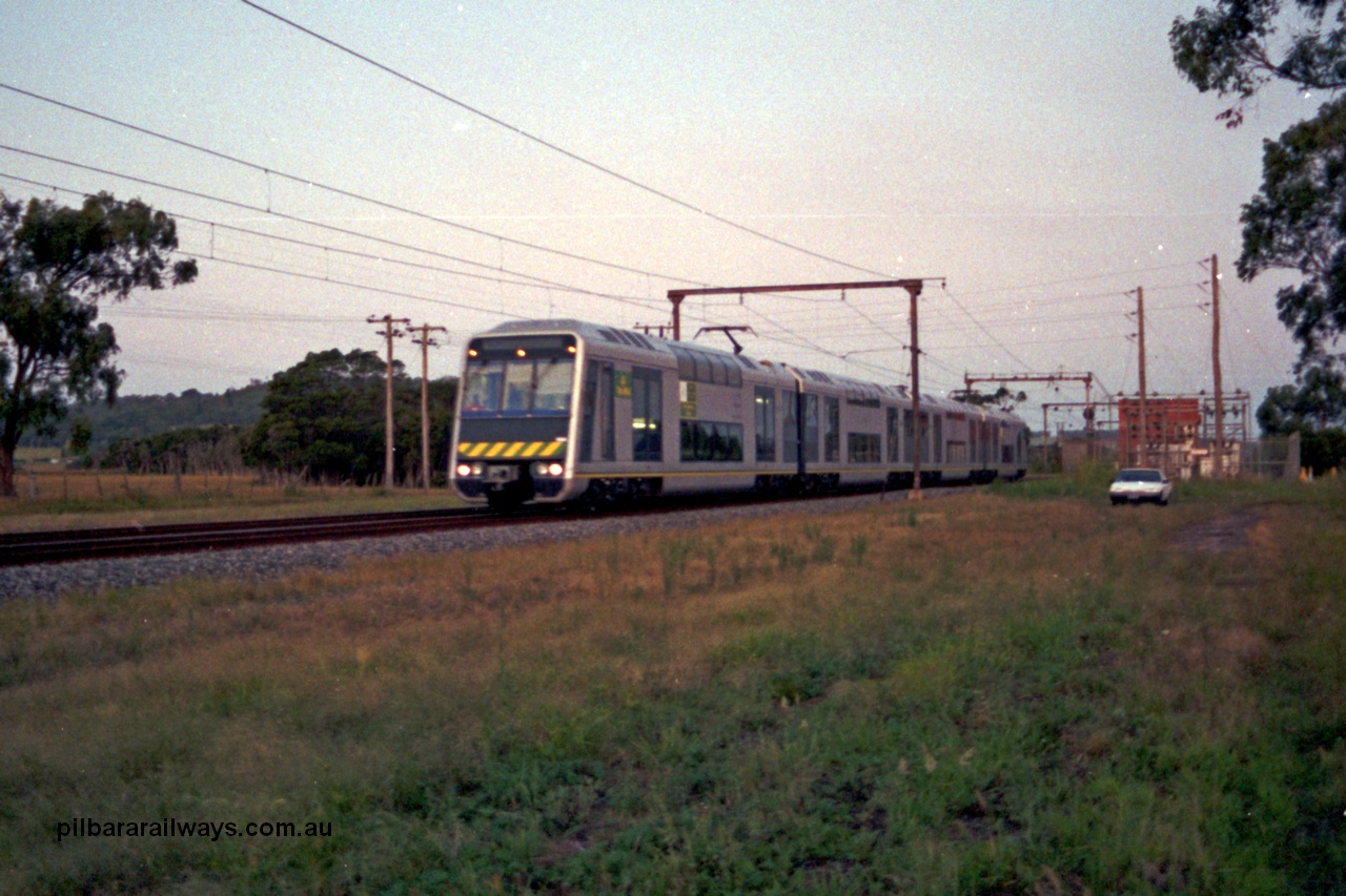 129-1-06
Nar Nar Goon - Tynong section, west of Tynong, 4D (Double Deck Development and Demonstration), double deck suburban electric set, testing phase. The set was built by Goninan NSW in December 1991 as a 'Tamgara' model.
Keywords: 4D;Double-Deck-Development-Demonstration-train;Goninan-NSW;Tangara;