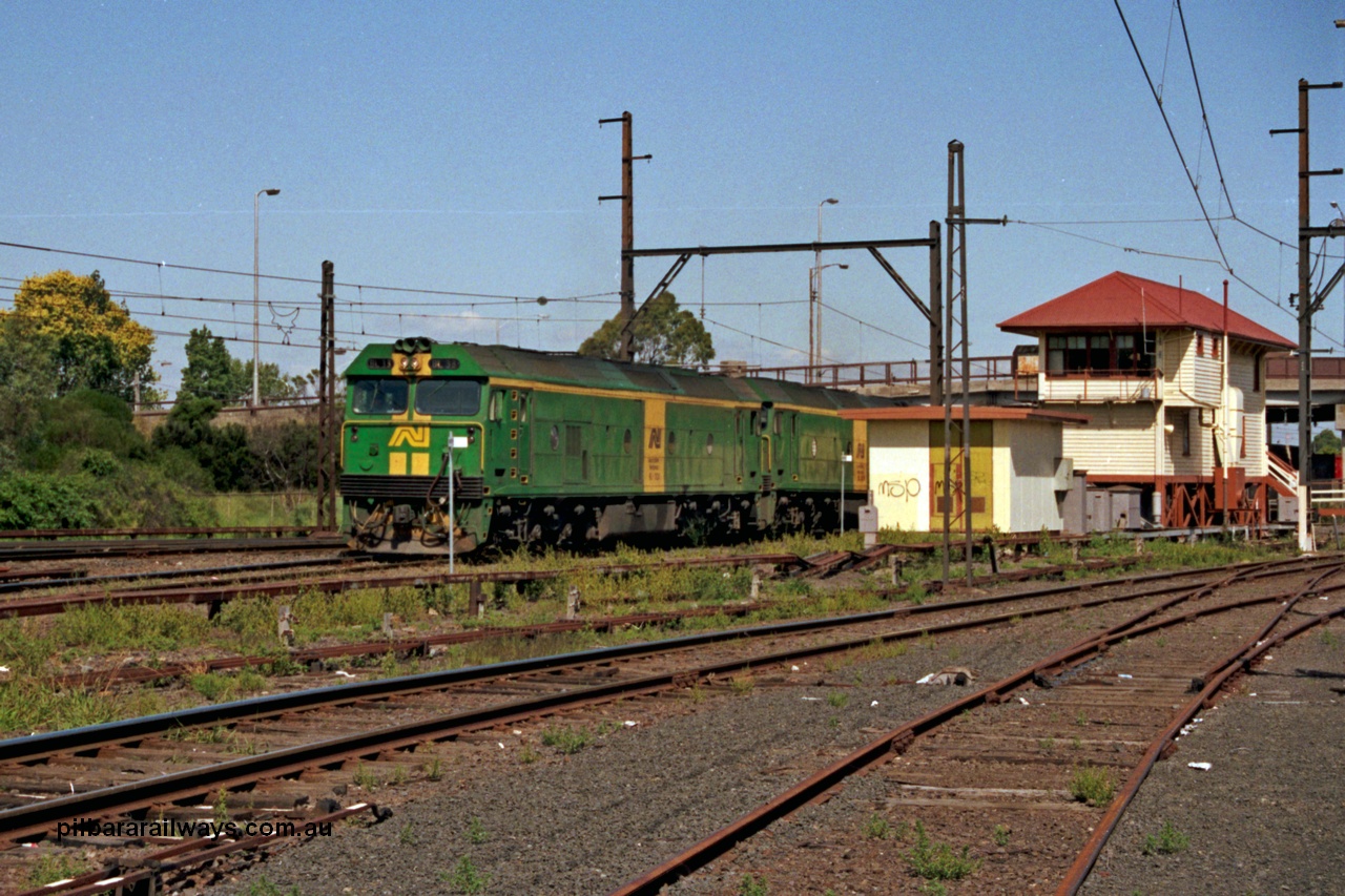 129-1-07
Sunshine, Australian National BL classes BL 33 Clyde Engineering EMD model JT26C-2SS serial 83-1017 and BL 32 serial 83-1016 in AN livery, lead a broad gauge down Adelaide goods train along No.2 Rd onto the South Line, signal box, points and point rodding, Sunshine still mechanically interlocked.
Keywords: BL-class;BL33;Clyde-Engineering-Rosewater-SA;EMD;JT26C-2SS;83-1017;