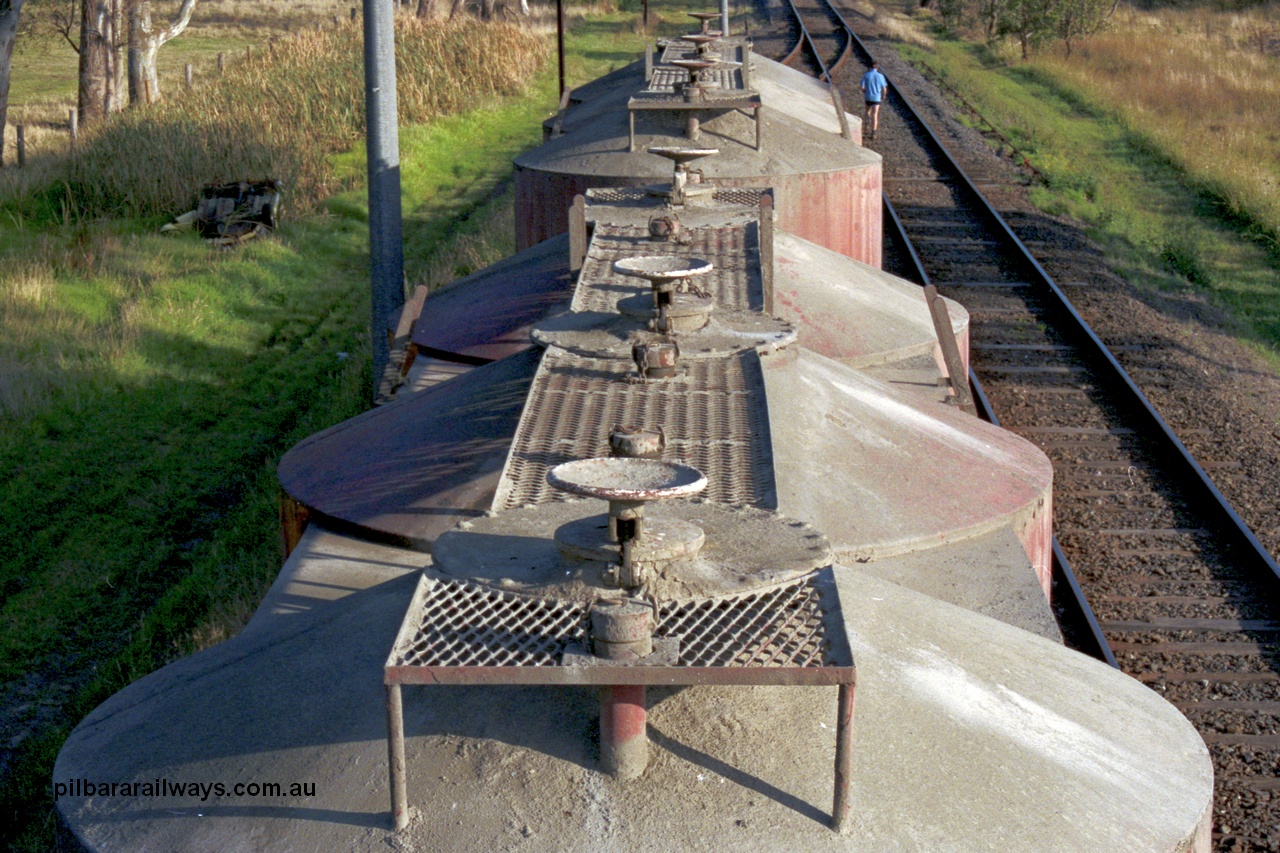 129-1-12
Lyndhurst, detail roof view of V/Line broad gauge VPCX type bogie cement waggons. Location is [url=https://goo.gl/maps/APmJrHjskZH4gvxa6]Geo Data[/url].
Keywords: VPCX-type;