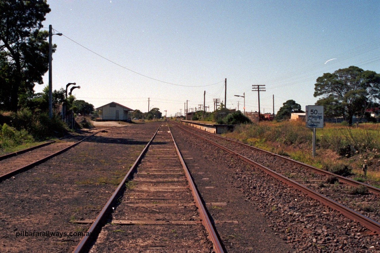 129-1-33
Cranbourne station overview, looking towards Koo Wee Rup, loading ramp and goods shed on the left, station platform and building on the right.
