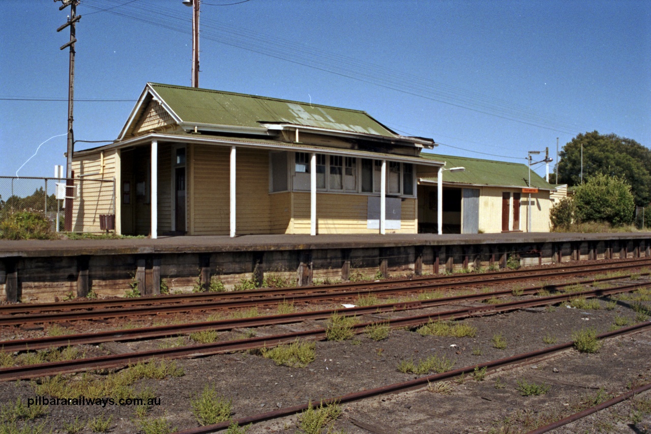 129-1-35
Koo Wee Rup station building overview, station platform, building showing signs of fire damage, track view.
