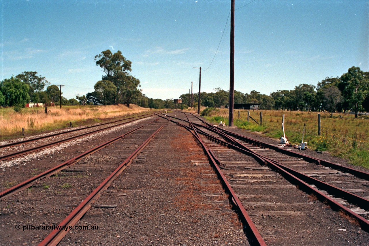 129-2-08
Nyora yard overview, looking in the up direction towards Melbourne, right road leads to turntable, water tank, tracks removed, double compound points.
