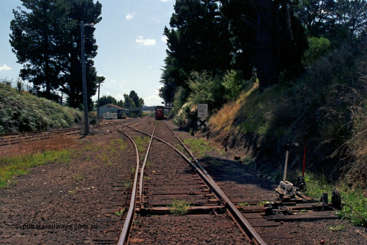 129-2-25
Leongatha station overview, looking towards Melbourne from west end, points and point and signal levers with interlocking, stabled broad gauge V/Line passenger train at platform, P class P 11 Clyde Engineering EMD model G18HBR serial 84-1205 rebuilt from T 336 Clyde Engineering EMD model G8B serial 56-110 and H set.
