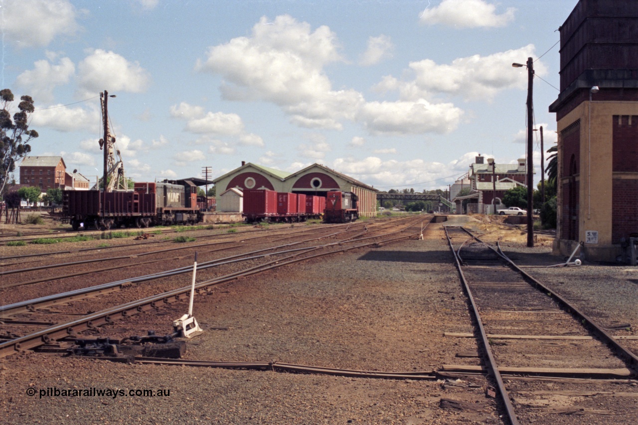 131-1-08
Echuca yard overview, looking north, V/Line broad gauge class leaders of the H class H 1 Clyde Engineering EMD model G18B serial 68-629 and the X class X 31 Clyde Engineering EMD model G16C serial 66-484, goods shed, station building, water tower at right, point levers, track work.
