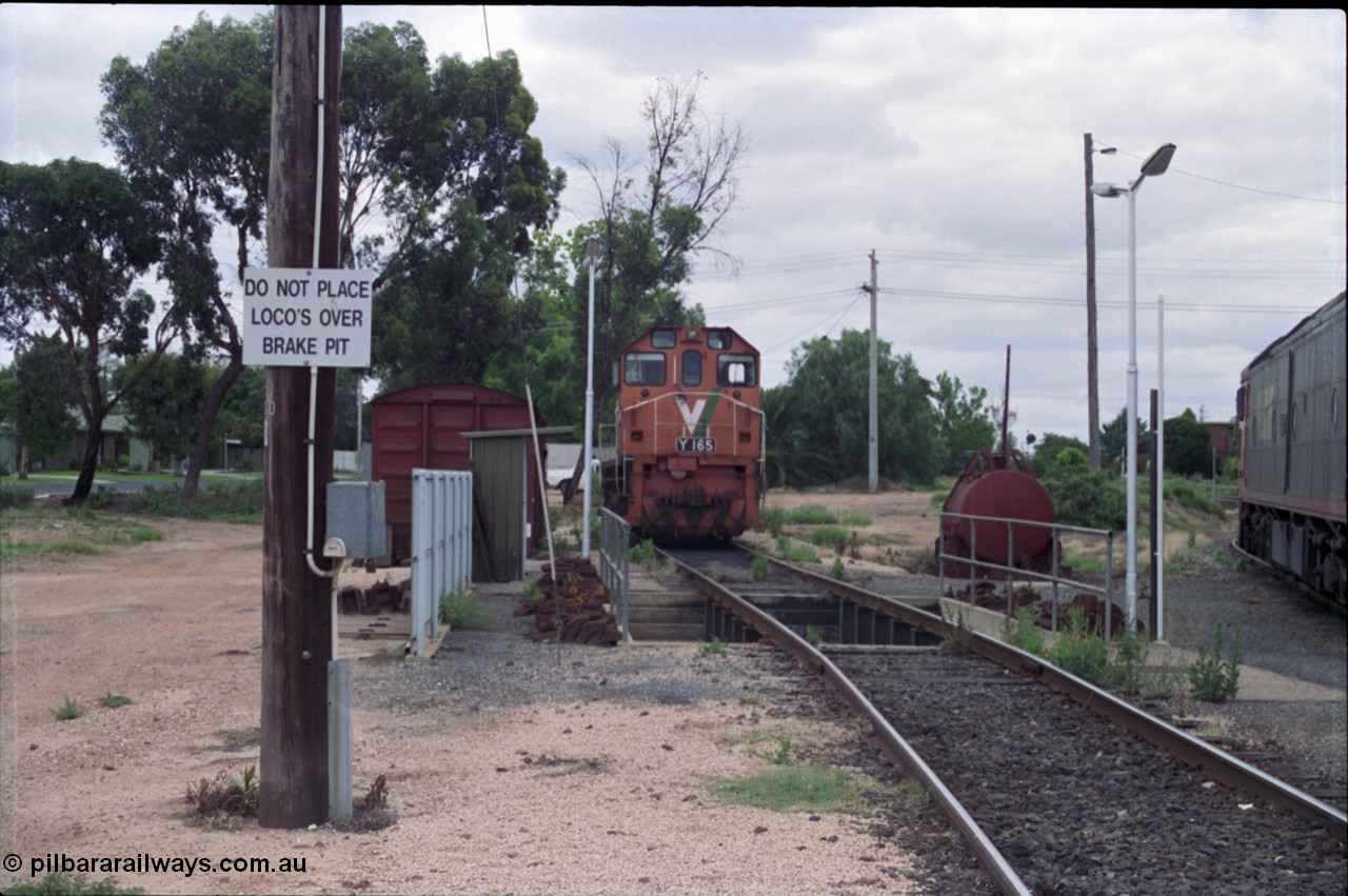 132-23
Mildura loco depot, looking north, grounded B van, brake pit, V/Line broad gauge Y class Y 165 Clyde Engineering EMD model G6B serial 68-585.
Keywords: Y-class;Y165;Clyde-Engineering-Granville-NSW;EMD;G6B;68-585