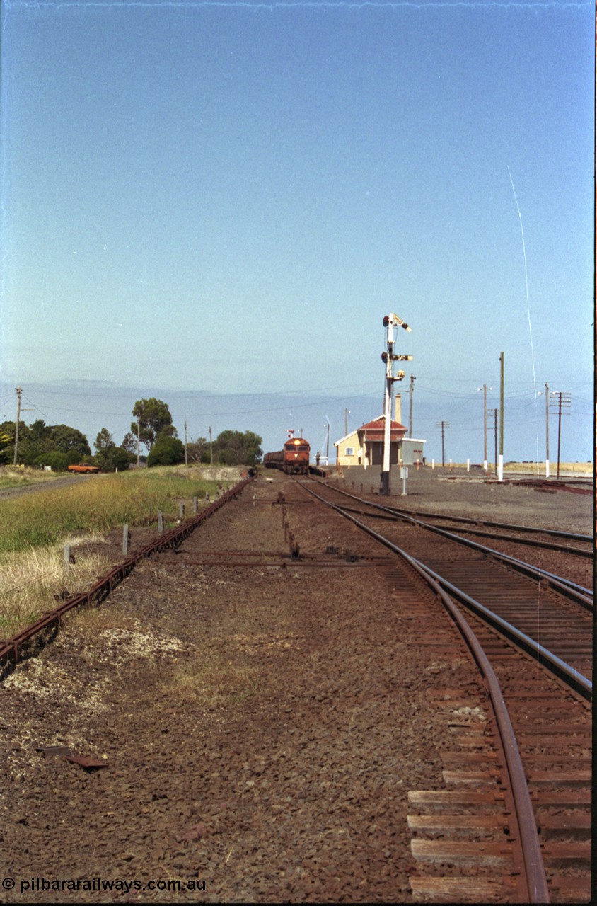133-31
Gheringhap station yard overview, looking from Ballarat line points towards Geelong, semaphore signal post 4 pulled off for Cressy line, points, point rodding, signal wires and interlocking, V/Line broad gauge grain train 9123 swapping electric staff for train order for Maroona, safeworking.
Keywords: G-class;G533;Clyde-Engineering-Somerton-Victoria;EMD;JT26C-2SS;88-1263;