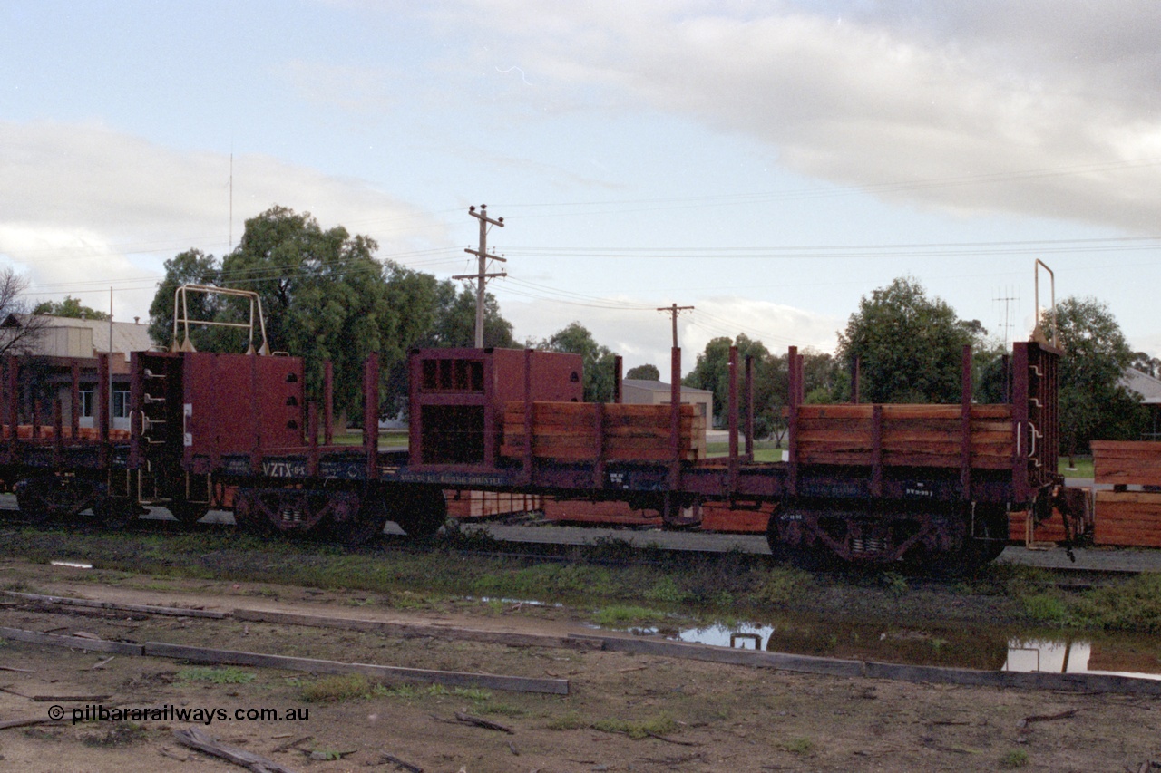 136-03
Mathoura, broad gauge V/Line VZTX class bogie sleeper carrying waggon VZTX 6 half loaded, new sleepers stockpiled in yard.
Keywords: VZTX-type;VZTX6;