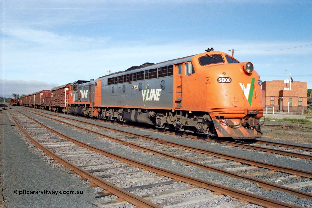 137-1-04
Seymour station yard view, broad gauge V/Line S class leader S 300 'Matthew Flinders' Clyde Engineering EMD model A7 serial 57-164 on the point of stabled down Wodonga goods train 9303 with T class T 396 Clyde Engineering EMD model G8B serial 65-426, a ballast rake is in the background and the yard has been rationalised.
Keywords: S-class;S300;Clyde-Engineering-Granville-NSW;EMD;A7;57-164;bulldog;