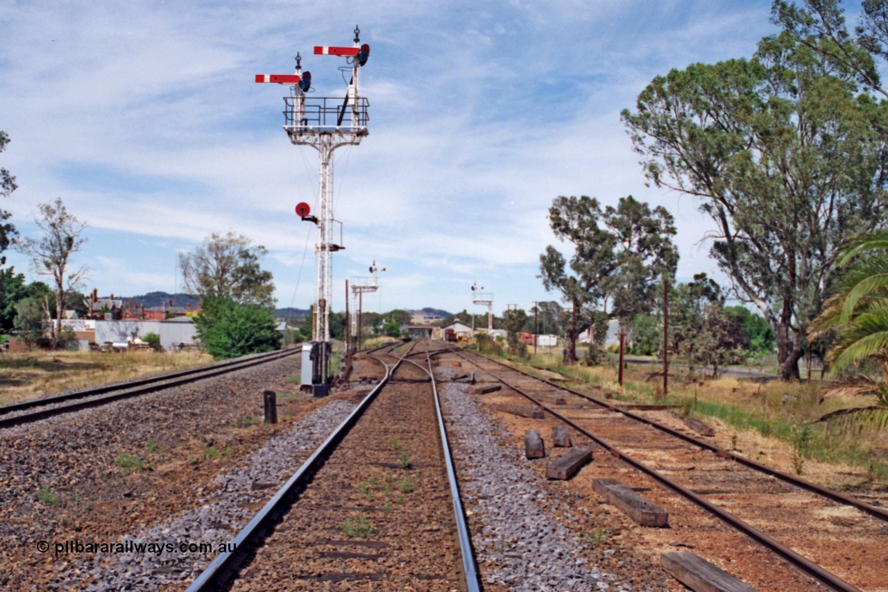 137-1-11
Euroa, station yard overview, up home lattice semaphore signal post 6, with down home departure signal post 5 and 4 in the background, No.3 Rd extension at right while the standard gauge line is on the left.
