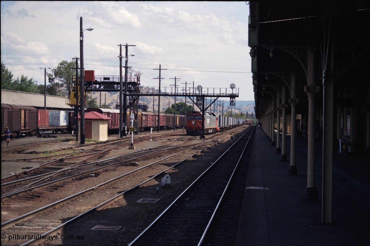 137-2-04
Albury station yard overview, standard gauge V/Line G class loco G 518 Clyde Engineering EMD model JT26C-2SS serial 85-1231 has just arrived with down goods from Melbourne, the G class will cut off and run to loco. Immediately to the left of the G class is the broad gauge goods loop.
Keywords: G-class;G518;Clyde-Engineering-Rosewater-SA;EMD;JT26C-2SS;85-1231;