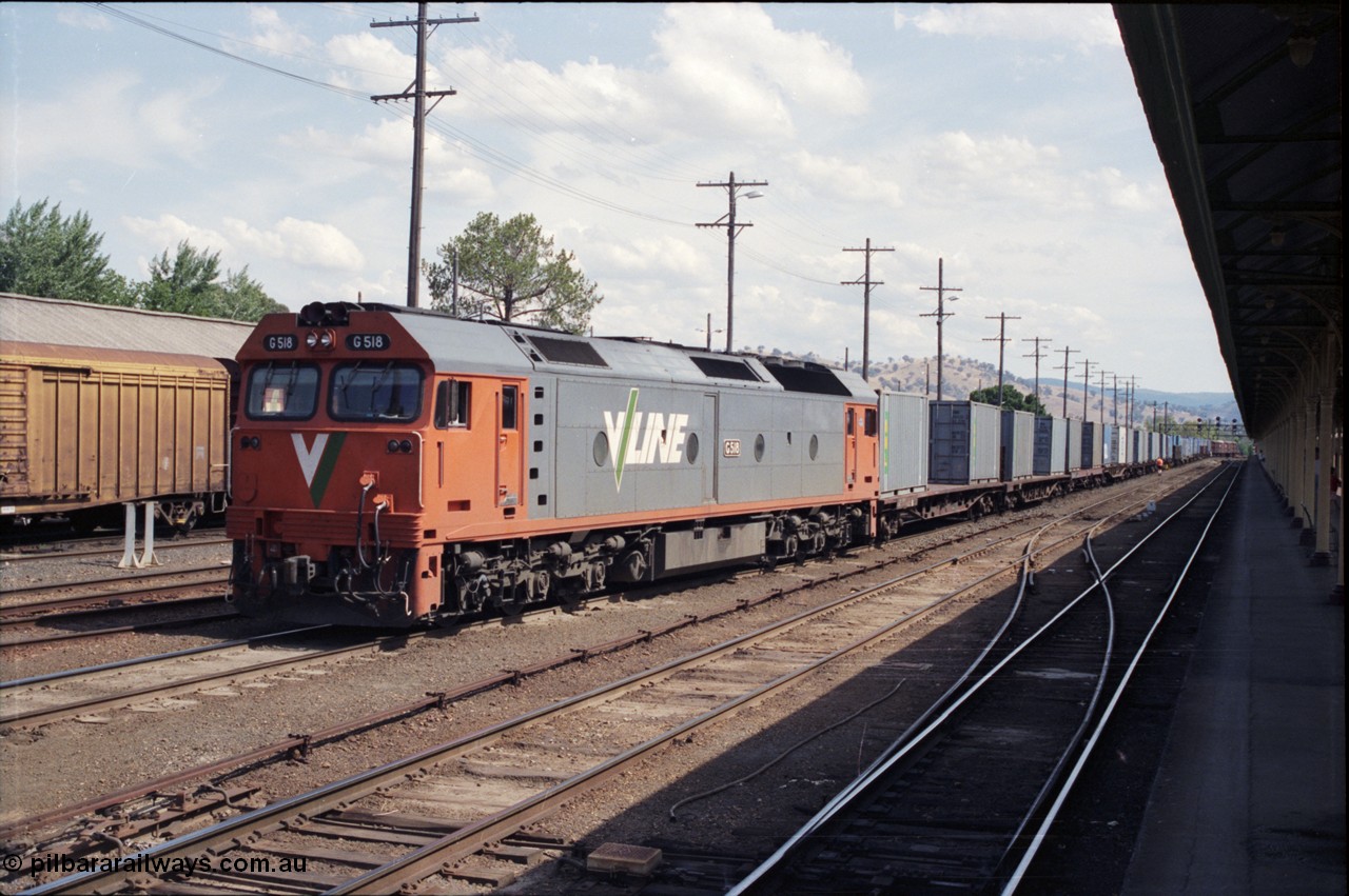 137-2-05
Albury station yard view, V/Line standard gauge locomotive G class G 518, Clyde Engineering EMD model JT26C-2SS serial 85-1231, has arrived with a down goods from Melbourne and waits to cut off as was the standard practice of the era, NSW will then re-marshall the consist for the trip to Sydney.
Keywords: G-class;G518;Clyde-Engineering-Rosewater-SA;EMD;JT26C-2SS;85-1231;