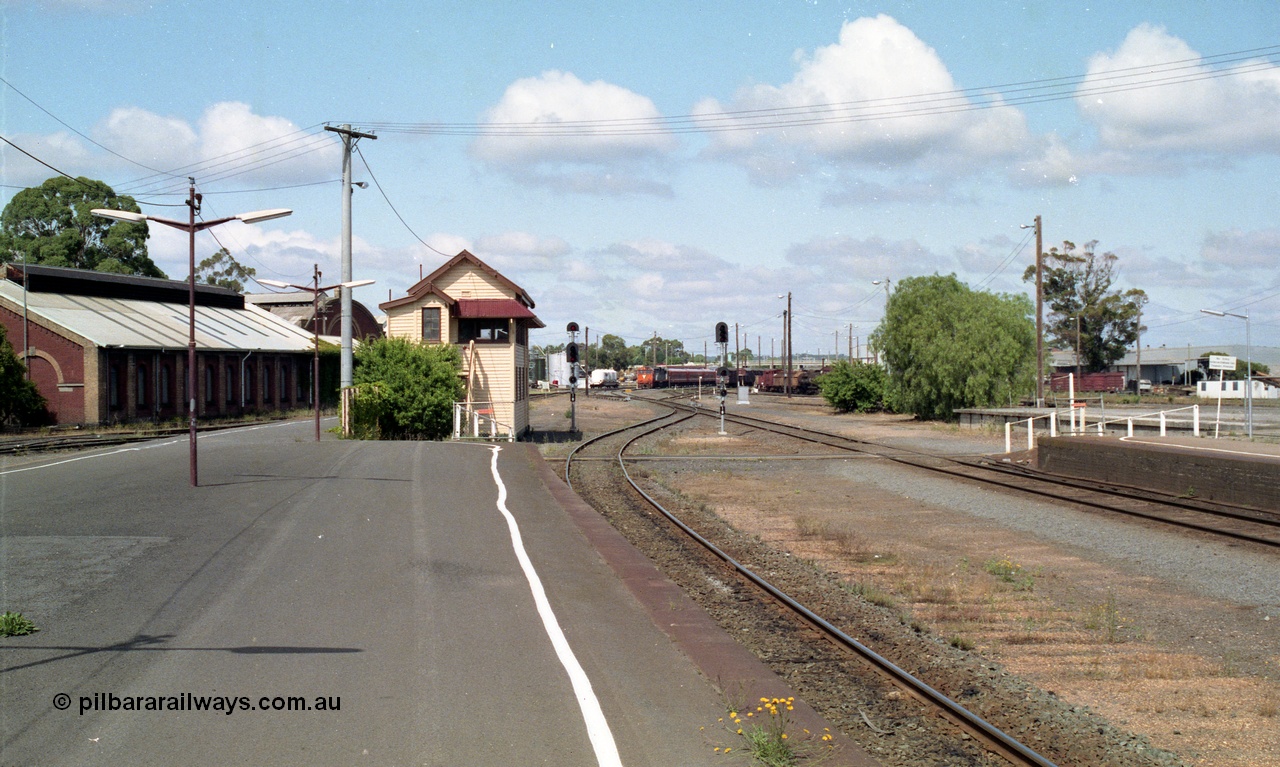 138-11
Bendigo station overview looking south past Bendigo A box, workshops at left, yard has been rationalised and mechanical signalling removed, N class arriving with down passenger in the background.
