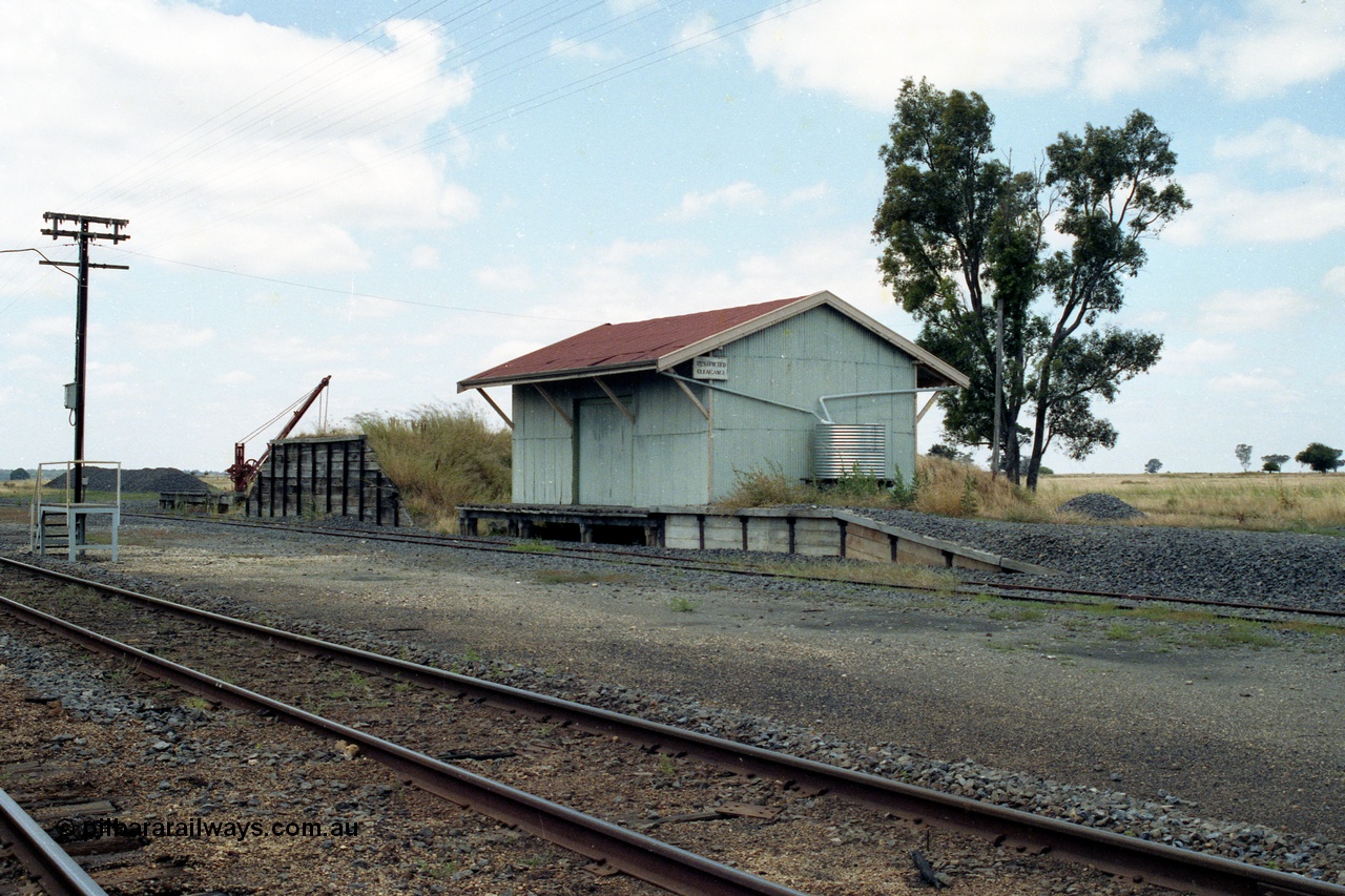138-23
Talbot, yard overview, staff exchange platform, on loop, yard crane and platform, loading ramp, goods shed and platform, piles of ballast.
