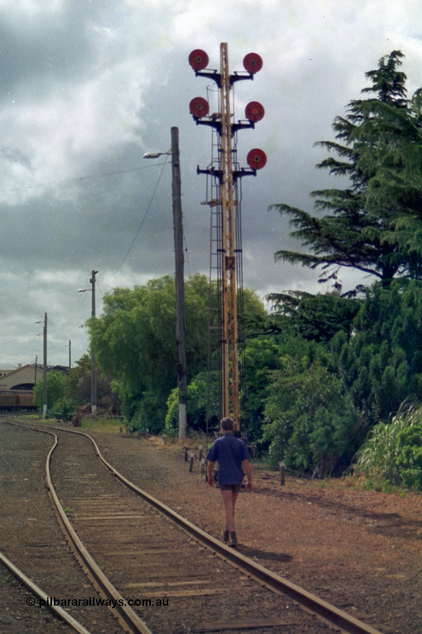 139-12
Ballarat yard disc signal Post 12 originally had six semaphores then six discs and in 1991 it was down to five discs. Not long after this view was taken the interlocked yard at Ballarat was rationalised and electrified with point motors and colour light signals taking over and all the old interlocked sidings had their interlocking removed. The top left hand Disc to the Car Sidings behind the station, centre left Disc towards Post No. 21 for No. 1 Road, removed bottom left Disc was towards Post No. 22 for No. 2 Road (also removed), top right hand Disc to Post No. 23 for No. 3 Road, centre right Disc towards Post No. 20 for No. 4 Road and the bottom right Disc to point 'D' towards Post No. 14 which led into the back road and the goods sheds and platforms.

