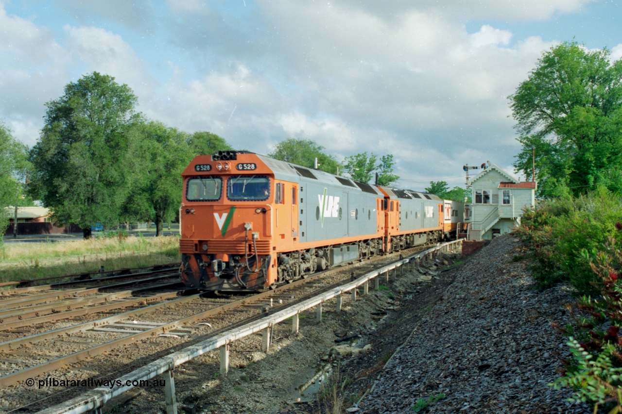 139-25
North Ballarat or Ballarat C Signal Box, broad gauge V/Line G class pair with G 528 Clyde Engineering EMD model JT26C-2SS serial 88-1258 leads an Adelaide bound down goods train, the track at the far left leads to Maryborough while the middle track branches to Ballarat North Workshops.
Keywords: G-class;G528;Clyde-Engineering-Somerton-Victoria;EMD;JT26C-2SS;88-1258;