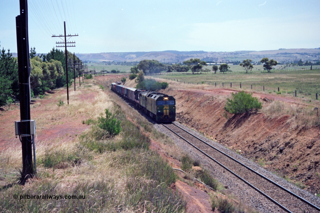 140-1-01
Parwan, up broad gauge Melbourne bound goods climbing Parwan Bank from Bacchus Marsh, could be 9150? Australian National locos BL class Clyde Engineering EMD model JT26C-2SS and 700 class AE Goodwin ALCo model DL500G combined with a V/Line C class provide the power.
Keywords: BL-class;Clyde-Engineering-Rosewater-SA;EMD;JT26C-2SS;