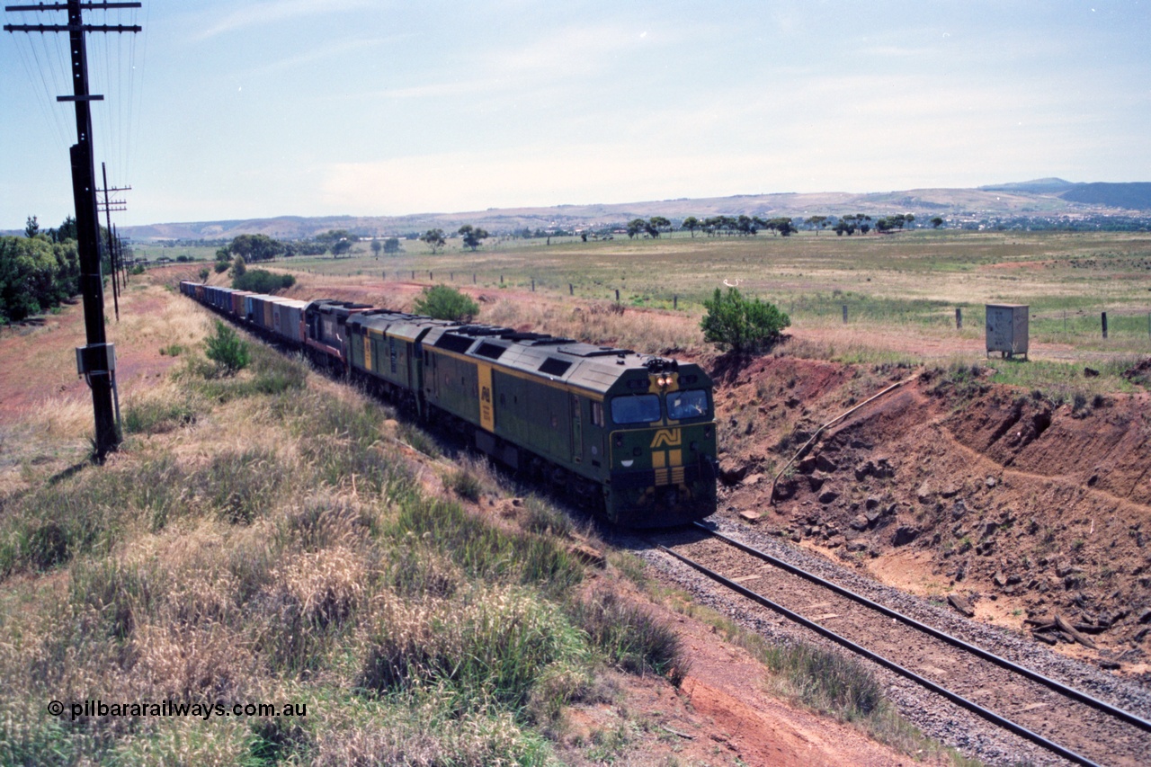 140-1-02
Parwan, up broad gauge Melbourne bound goods climbing Parwan Bank from Bacchus Marsh, could be 9150? Australian National locos BL class Clyde Engineering EMD model JT26C-2SS and 700 class AE Goodwin ALCo model DL500G combined with a V/Line C class provide the power.
Keywords: BL-class;Clyde-Engineering-Rosewater-SA;EMD;JT26C-2SS;
