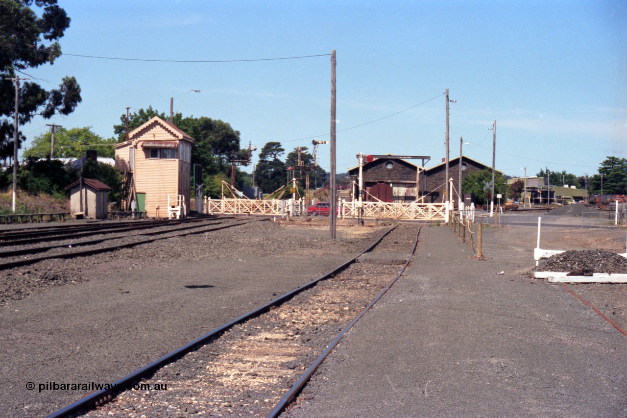 140-1-16
Ballarat East signal box overview, looking east, signal box and staff exchange platform, Humffray St interlocked gates, 2 sets, bluestone goods shed and gantry crane, disc signal post 6A, taken from the loco track.
