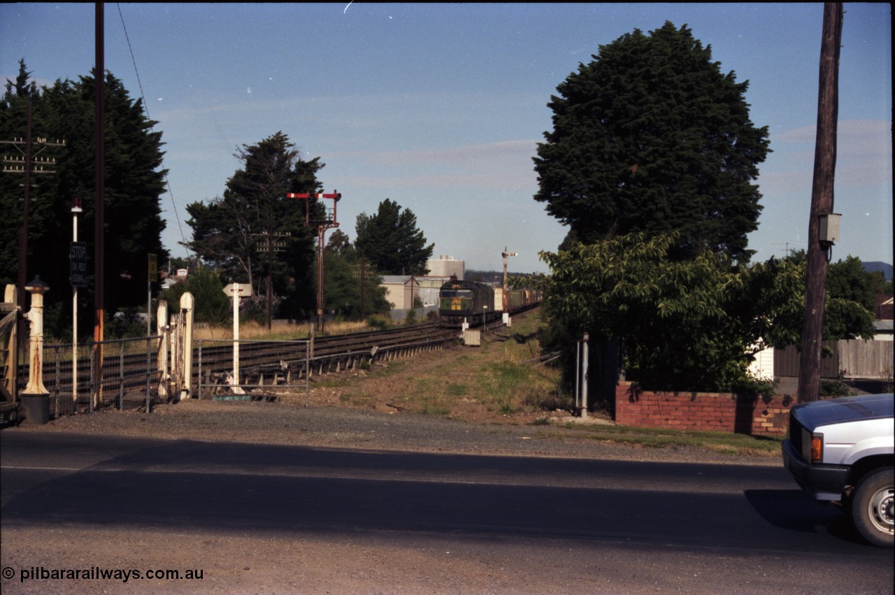 140-2-06
Ballarat, Linton Junction Signal Box, or Ballarat D, looking towards Ballarat, Australian National BL class BL 27 Clyde Engineering EMD model JT26C-2SS serial 83-1011 leads a down Adelaide bound goods train on approach to Linton Junction having just past semaphore signal post 20, semaphore signal post 19 is on the left, looking east across Gillies Street.
Keywords: BL-class;BL27;Clyde-Engineering-Rosewater-SA;EMD;JT26C-2SS;83-1011;