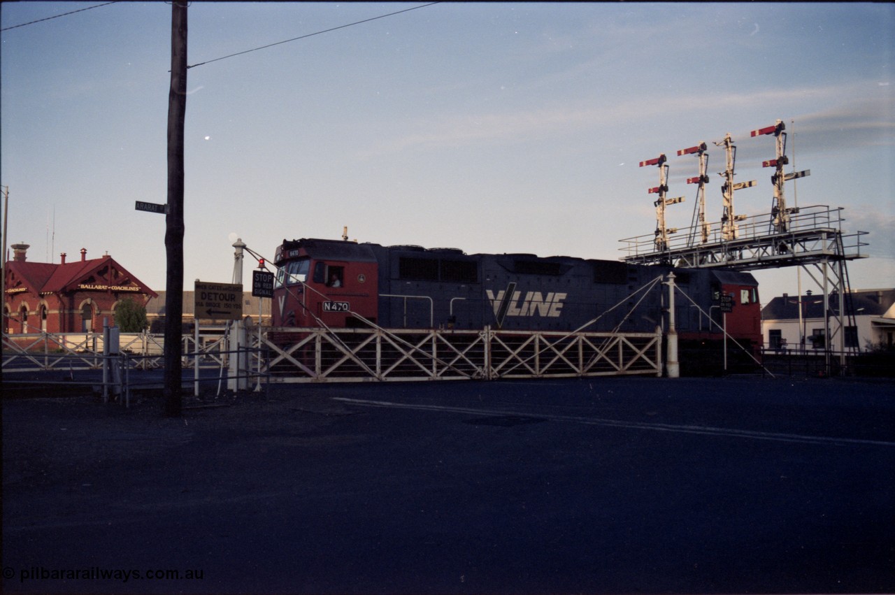 140-2-13
Ballarat station, V/Line broad gauge N class N 470 'City of Wangaratta' Clyde Engineering EMD model JT22HC-2 serial 86-1199 crosses Lydiard Street as it runs round the carriage set, through the interlocked gates and under the semaphore signal gantry.
Keywords: N-class;N470;Clyde-Engineering-Somerton-Victoria;EMD;JT22HC-2;86-1199;