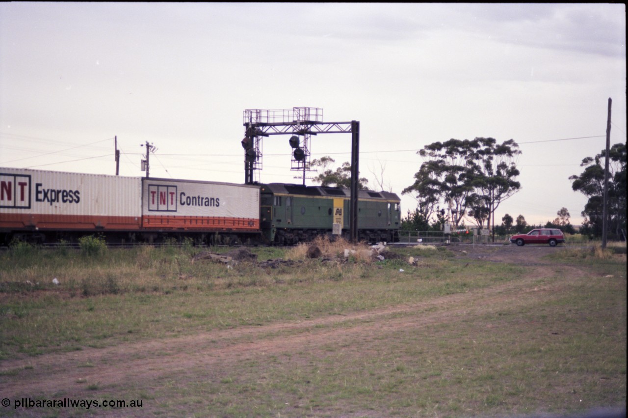 140-2-22
Deer Park West, Robinsons Road grade crossing, Australian National broad gauge BL class locomotive Clyde Engineering EMD model JT26C-2SS in AN livery leading a down Adelaide bound goods train.
Keywords: BL-class;Clyde-Engineering-Rosewater-SA;EMD;JT26C-2SS;