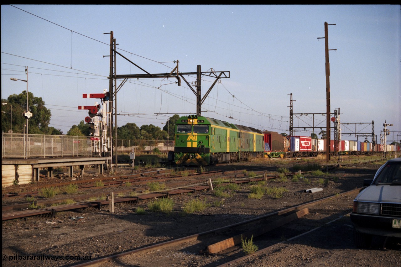 141-1-09
Sunshine, broad gauge Australian National BL class units BL 28 Clyde Engineering EMD model JT26C-2SS serial 83-1012 and BL 27 serial 83-1011 lead the second of the afternoon procession of down Adelaide bound goods trains out of Melbourne along the passenger lines and heading past platform No.3, semaphore and disc signal post, point rodding, station platforms.
Keywords: BL-class;BL28;Clyde-Engineering-Rosewater-SA;EMD;JT26C-2SS;83-1012;
