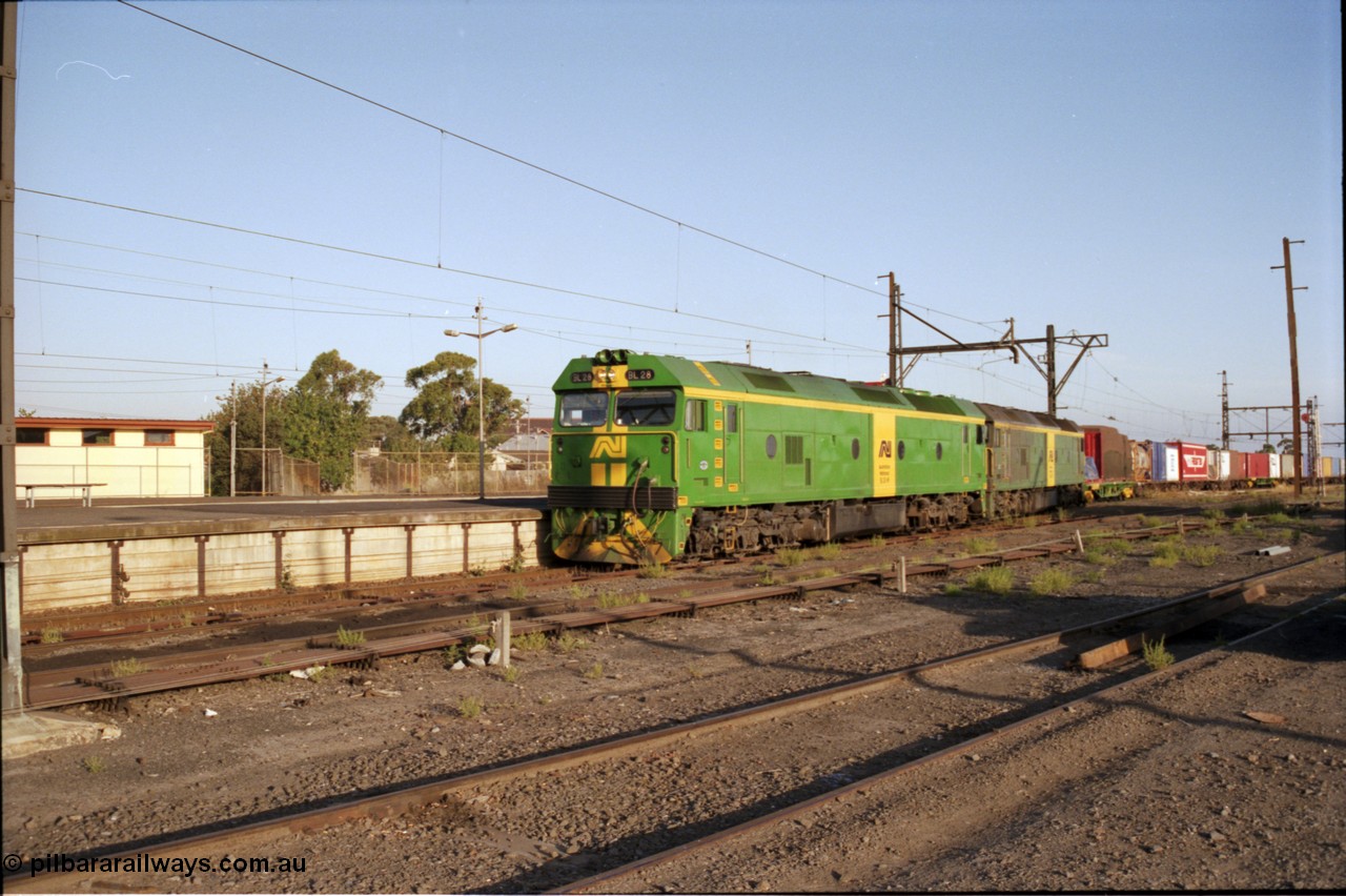141-1-10
Sunshine, broad gauge Australian National BL class units BL 28 Clyde Engineering EMD model JT26C-2SS serial 83-1012 and BL 27 serial 83-1011 lead the second of the afternoon procession of down Adelaide bound goods trains out of Melbourne along the passenger lines and heading past platform No.3, point rodding, station platforms.
Keywords: BL-class;BL28;Clyde-Engineering-Rosewater-SA;EMD;JT26C-2SS;83-1012;