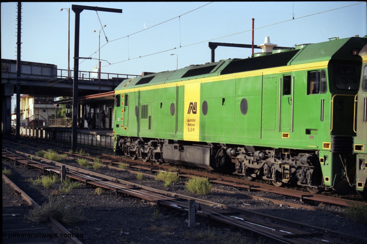 141-1-11
Sunshine, broad gauge Australian National BL class BL 28 Clyde Engineering EMD model JT26C-2SS serial 83-1012 runs along platform No.3 with a down Adelaide bound goods train, station platform, station building, point rodding and signal wires, signal box in the background, trailing view.
Keywords: BL-class;BL28;Clyde-Engineering-Rosewater-SA;EMD;JT26C-2SS;83-1012;