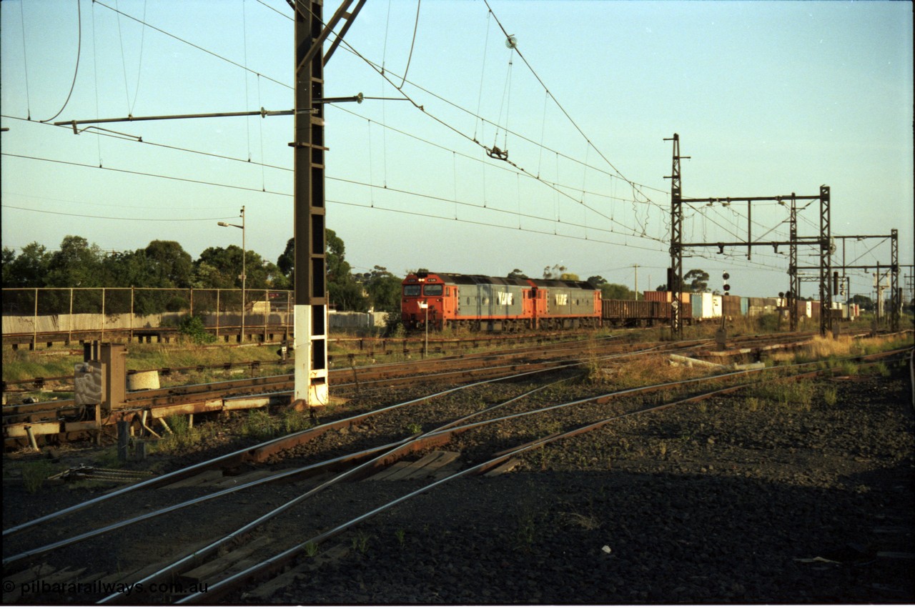 141-1-14
Sunshine Loop, standard gauge V/Line G class units double head a down goods train seen running through the long since removed crossing loop, looking from former broad gauge goods yard across broad gauge northern and western lines.
Keywords: G-class;Clyde-Engineering-Somerton-Victoria;EMD;JT26C-2SS;