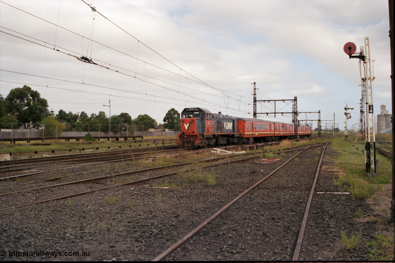 141-1-19
Sunshine, broad gauge V/Line P class P 18 Clyde Engineering EMD model G18HBR serial 84-1211 rebuilt from T 339 Clyde Engineering EMD model G8B serial 56-115 leads a 4 car H set with a down passenger train, on the right is disc signal post 34 which is for up moves from No. 4 road to the Loop Line, behind it is post 35 which is for down moves to No. 3 or 4 roads, I'm standing on 4 road, 3 road is to the left, the standard gauge platform is left of the train.
Keywords: P-class;P18;Clyde-Engineering-Somerton-Victoria;EMD;G18HBR;84-1211;rebuild;