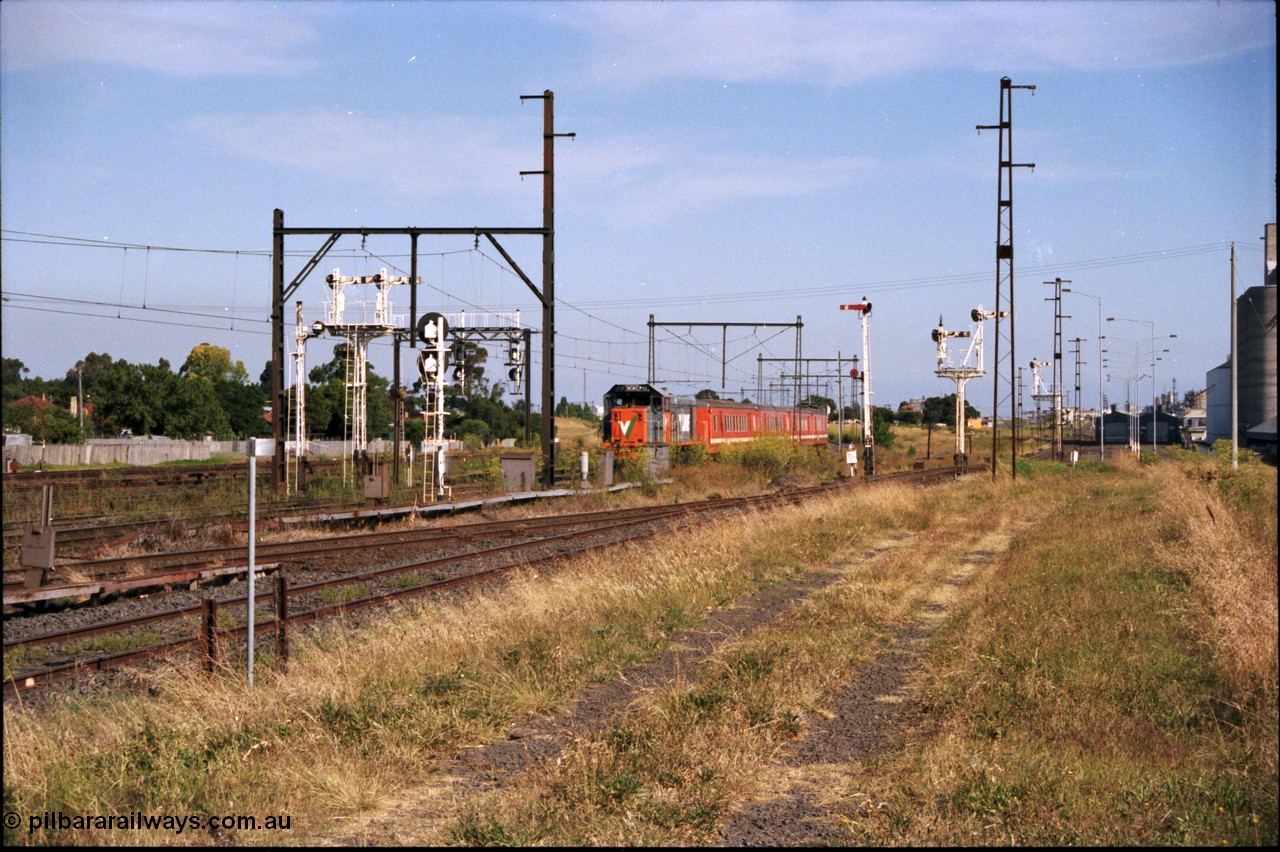 141-2-04
Sunshine, now there's a lot going on here apart from the Broad gauge V/Line P class P 17 Clyde Engineering EMD model G18HBR serial 84-1216 rebuilt from T 327 Clyde Engineering EMD model G8B serial 56-78 with a four car H set on a down passenger train, with have the signals from the left, disc signal post 31 and double doll semaphore signal post 31B for the Independent Through Lines, searchlight signal post 71 which is controlling the train, the signal gantry in the left background for the standard gauge Sunshine Loop, on the right of the train semaphore signal post 49 for the Newport Loop Line, double doll semaphore signal post 36 for down trains off the Newport Loop Line and then offset semaphore signal post 50 also for down trains out of the GEB sidings.
Keywords: P-class;P17;Clyde-Engineering-Somerton-Victoria;EMD;G18HBR;84-1216;rebuild;