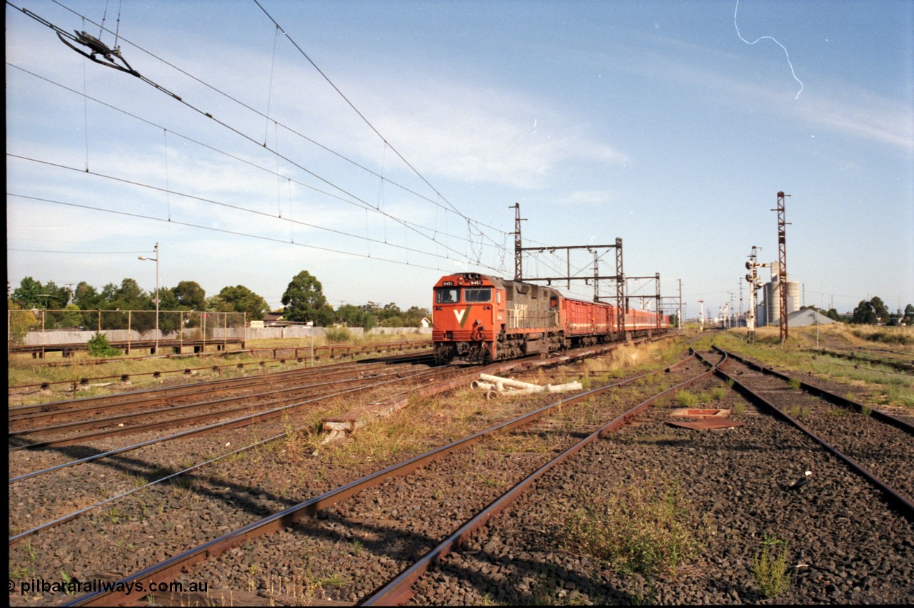 141-2-09
Sunshine, broad gauge V/Line down Swan Hill passenger train with N class leader N 451 'City of Portland' Clyde Engineering EMD model JT22HC-2 serial 85-1219, two D vans and N set, Newport Loop Line and GEB sidings can be seen on the right, the standard gauge platform can be seen at left.
Keywords: N-class;N451;Clyde-Engineering-Somerton-Victoria;EMD;JT22HC-2;85-1219;