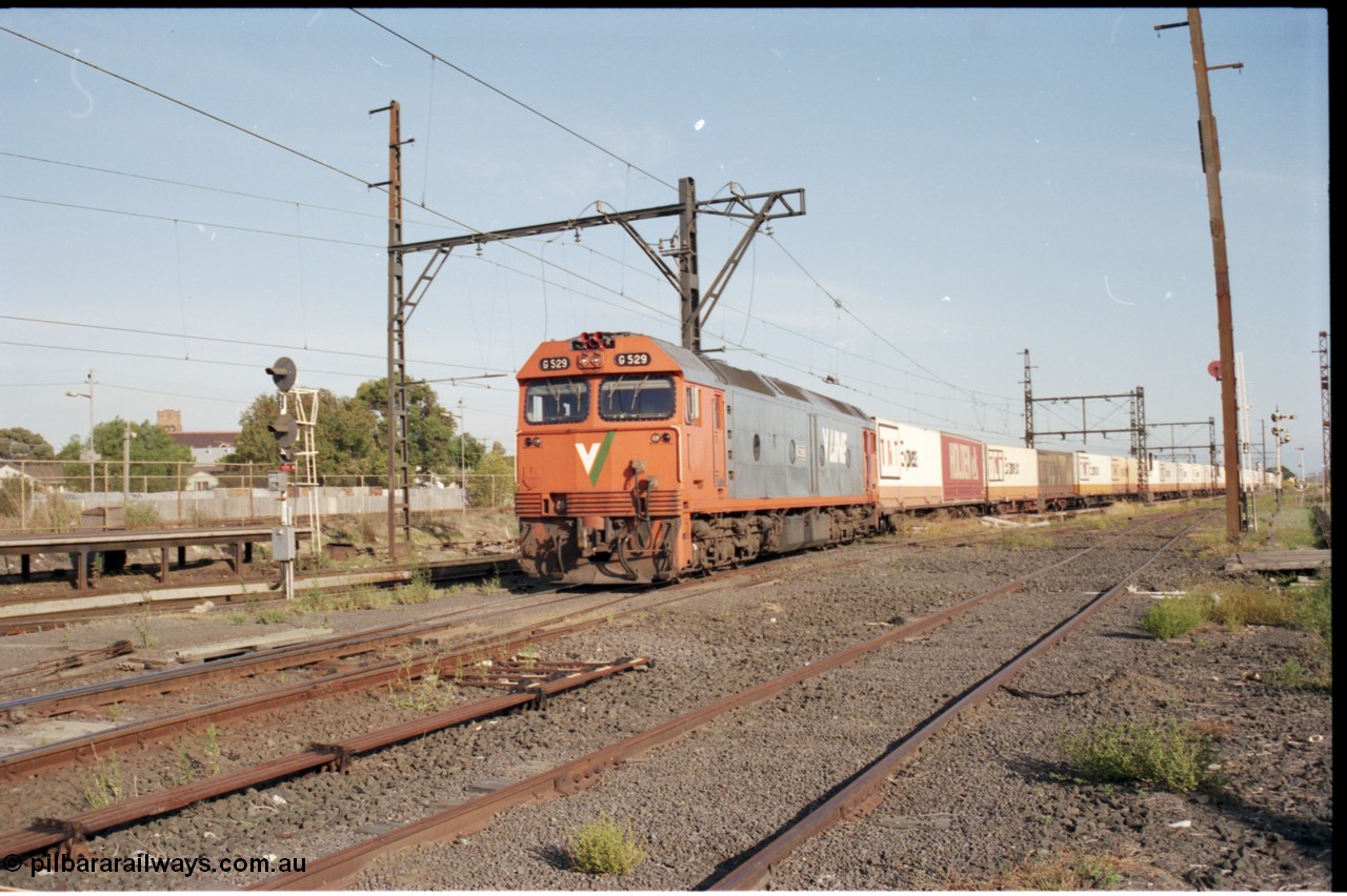 141-2-15
Sunshine, broad gauge V/Line G class G 529 Clyde Engineering EMD model JT26C-2SS serial 88-1259 solo leads an Adelaide bound down Super Freighter service with mainly TNT loading as it runs round the back of Sunshine through platform 3, looking east from former goods yard, point rodding.
Keywords: G-class;G529;Clyde-Engineering-Somerton-Victoria;EMD;JT26C-2SS;88-1259;