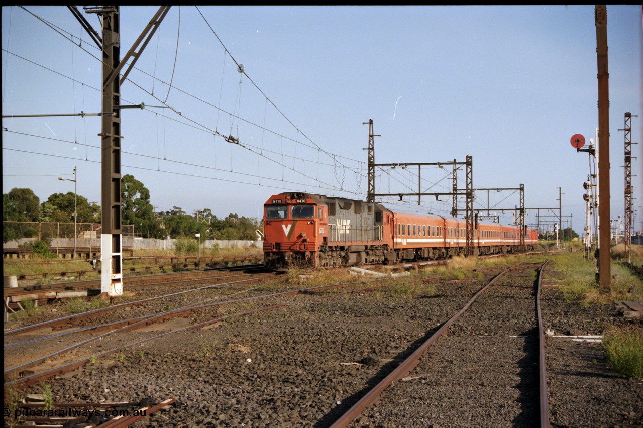 141-2-20
Sunshine, V/Line broad gauge N class N 470 'City of Wangaratta' Clyde Engineering EMD model JT22HC-2 serial 86-1199 with a five car Z set with D van on a down passenger service, taken from the former goods yard looking east.
Keywords: N-class;N470;Clyde-Engineering-Somerton-Victoria;EMD;JT22HC-2;86-1199;